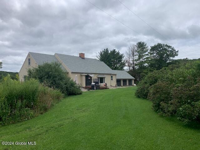 rear view of house with a lawn