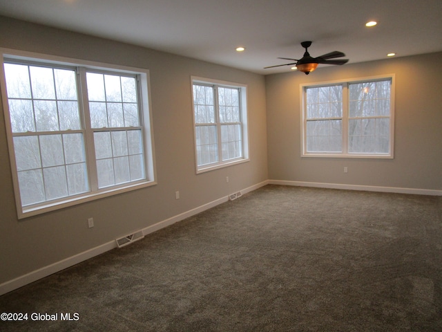 carpeted spare room featuring ceiling fan