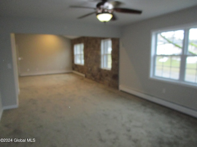 empty room with ceiling fan and carpet flooring