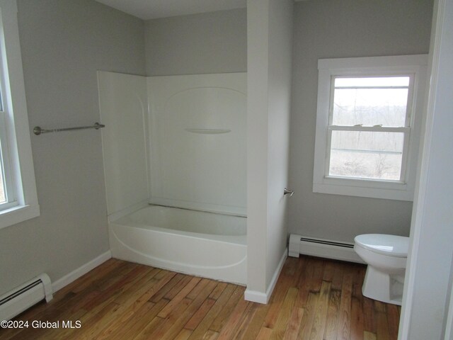 bathroom featuring shower / tub combination, wood-type flooring, toilet, and a baseboard radiator