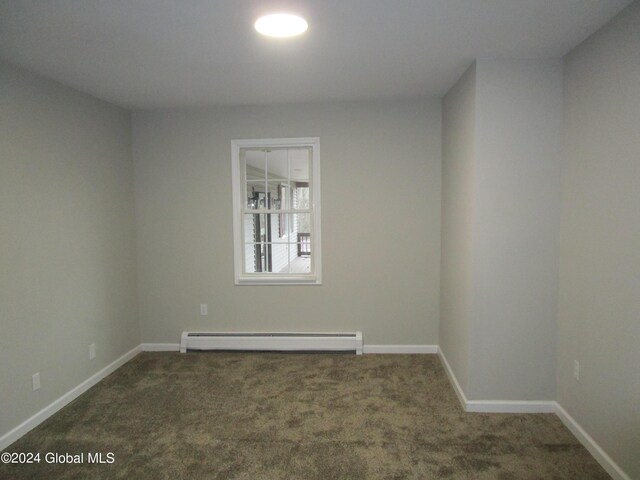 carpeted spare room with baseboard heating