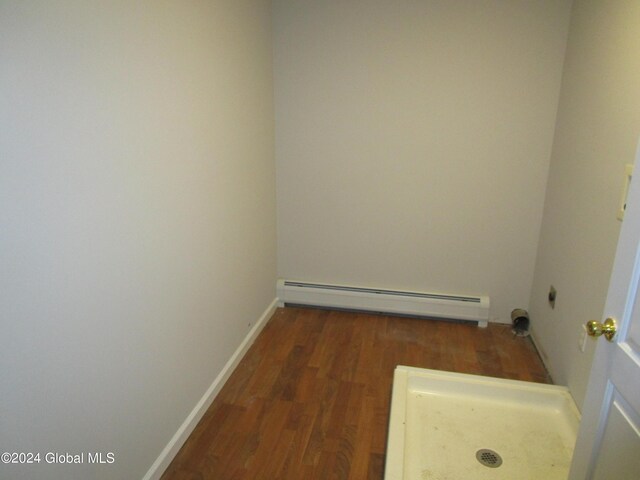 interior space with dark hardwood / wood-style floors and a baseboard radiator