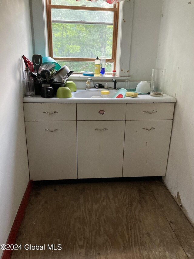 kitchen featuring sink and white cabinetry