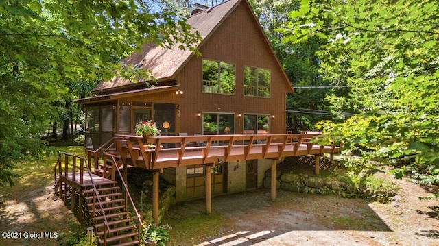 back of property with a wooden deck