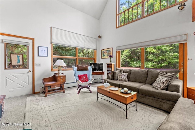 carpeted living room featuring a baseboard heating unit and high vaulted ceiling