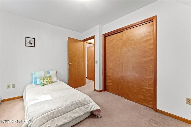 carpeted bedroom with a closet