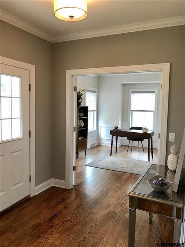 entrance foyer with dark hardwood / wood-style flooring and ornamental molding