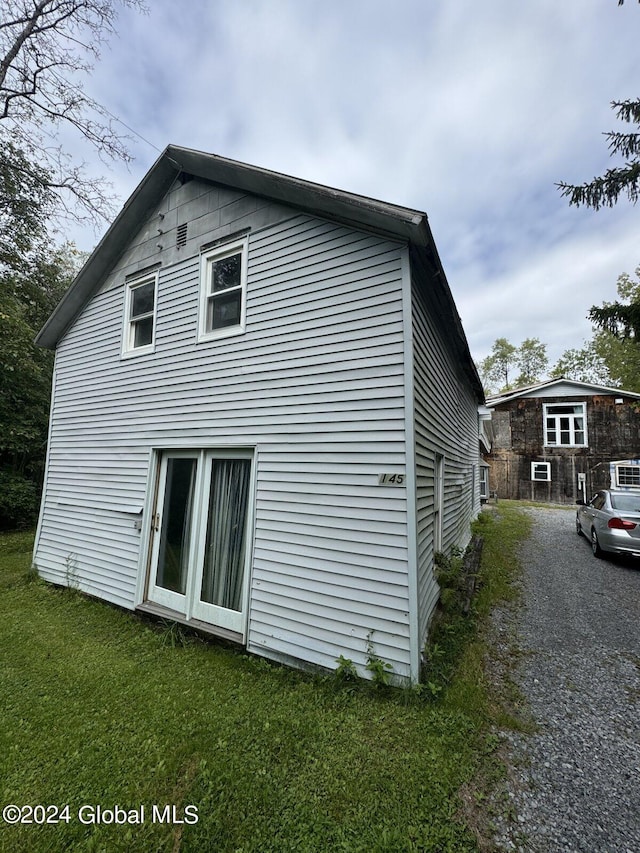 view of side of home featuring a yard