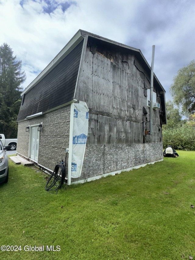 view of side of property with a lawn