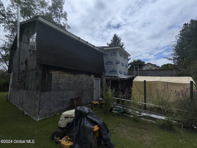 view of property exterior featuring a lawn