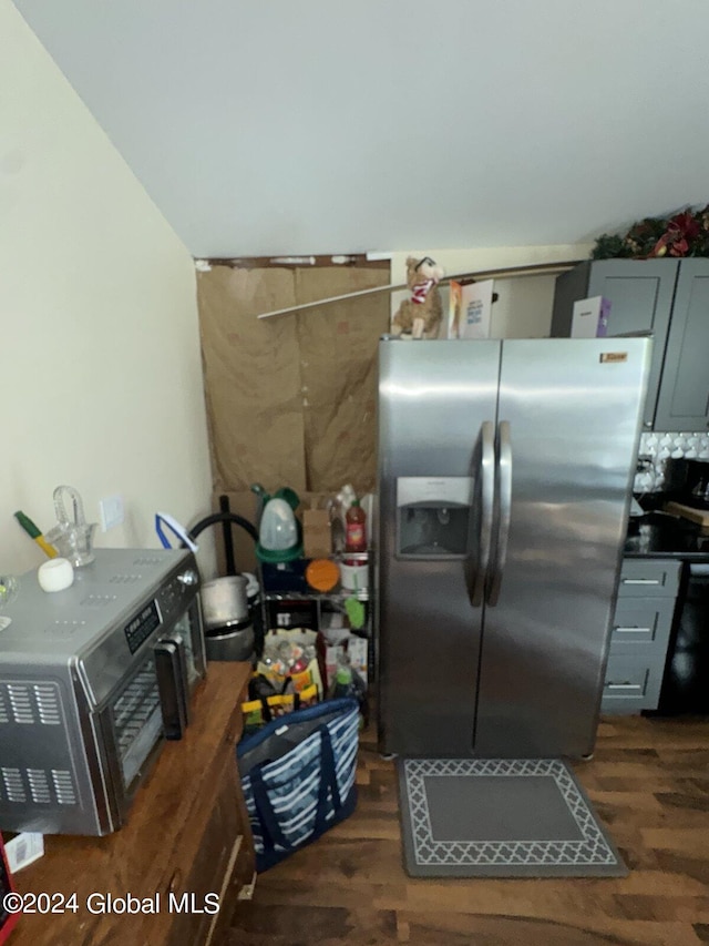 kitchen featuring gray cabinets, stainless steel fridge, and dark hardwood / wood-style flooring