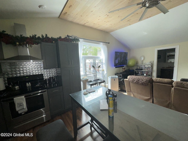 kitchen with hardwood / wood-style flooring, lofted ceiling, ceiling fan, decorative backsplash, and stainless steel range with electric cooktop