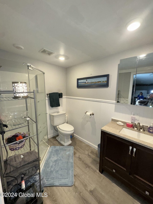 bathroom with vanity, toilet, and hardwood / wood-style floors