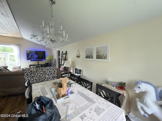 dining area featuring vaulted ceiling and a chandelier