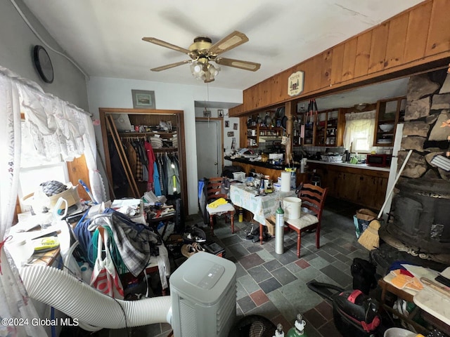 interior space featuring dark tile patterned floors and ceiling fan