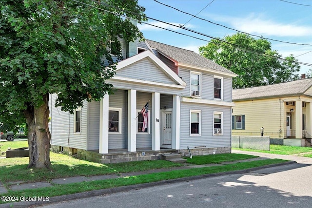 view of front of house featuring a front yard and roof with shingles