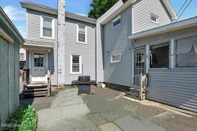 rear view of property with entry steps