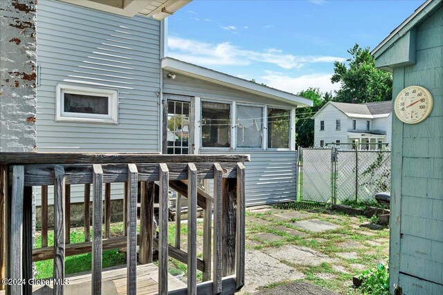 exterior space featuring a sunroom and fence