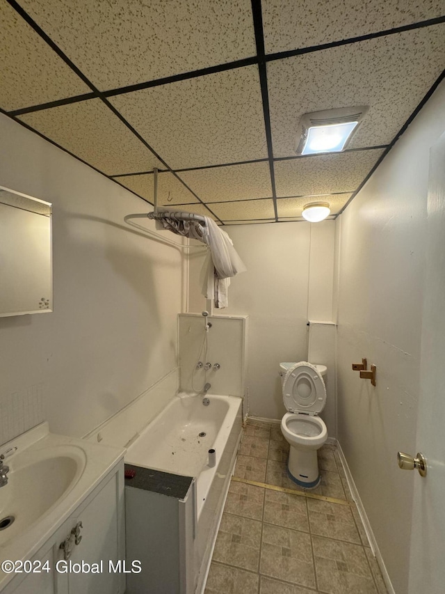 full bathroom with a paneled ceiling, toilet, bathtub / shower combination, and sink