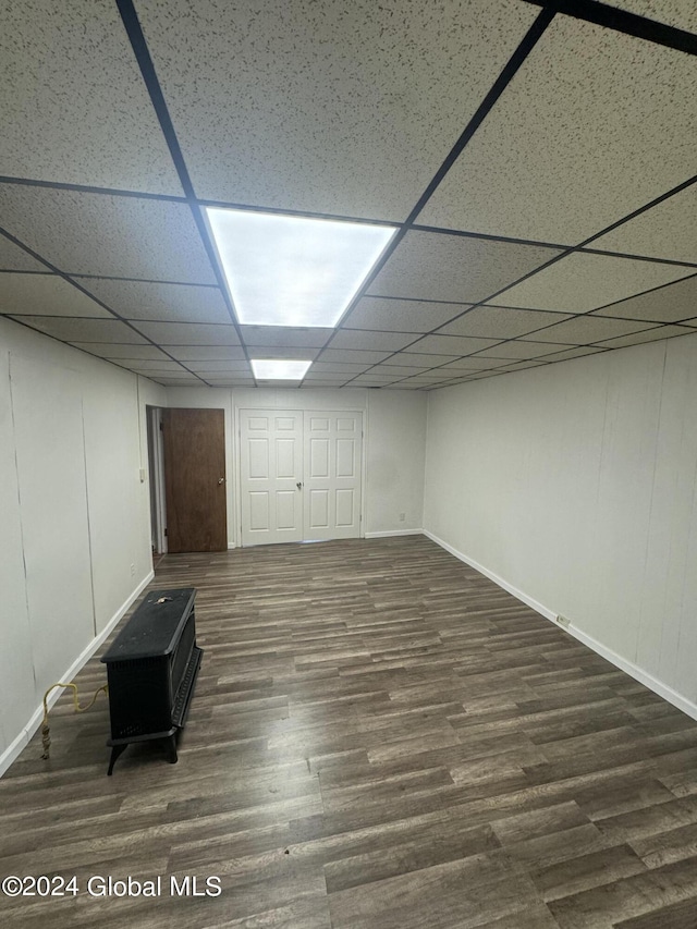 basement with dark wood-type flooring and a drop ceiling