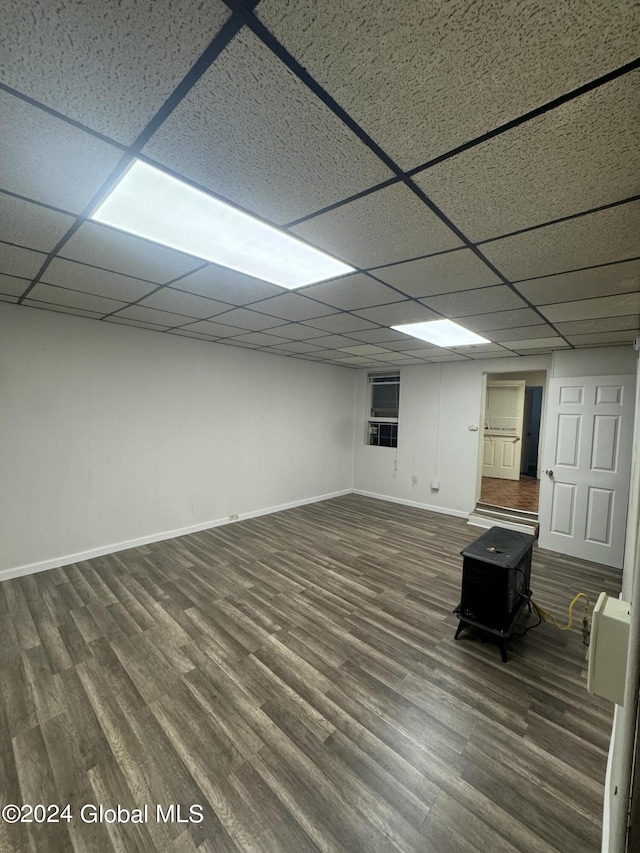 basement with hardwood / wood-style floors and a paneled ceiling