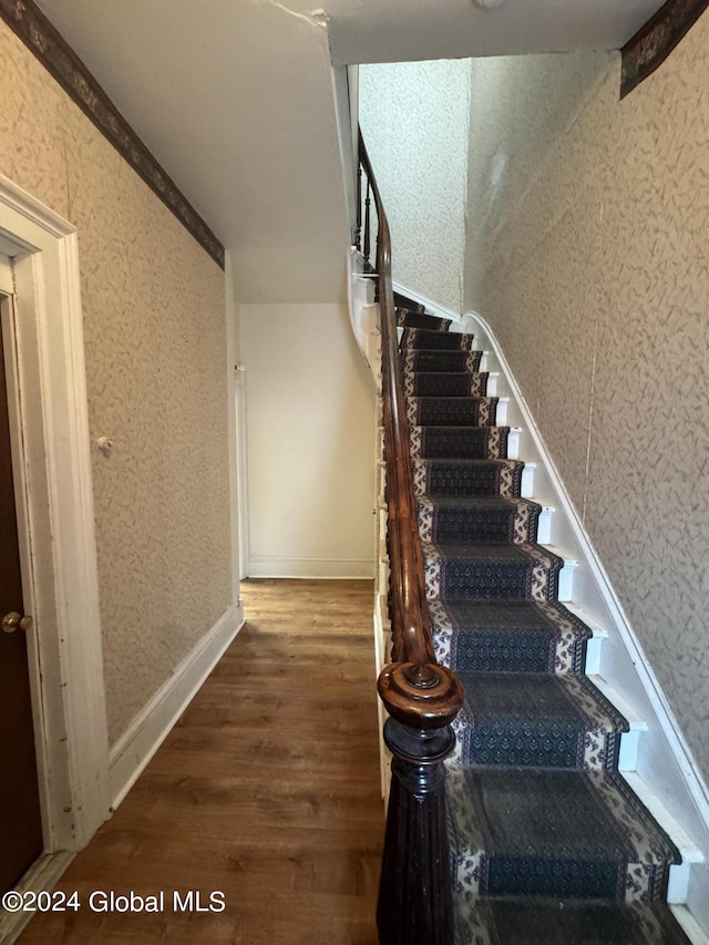 stairway featuring hardwood / wood-style floors