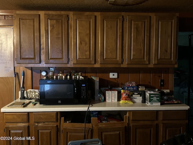 kitchen featuring black microwave and light countertops