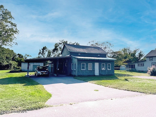 view of front of property with a front lawn and a carport