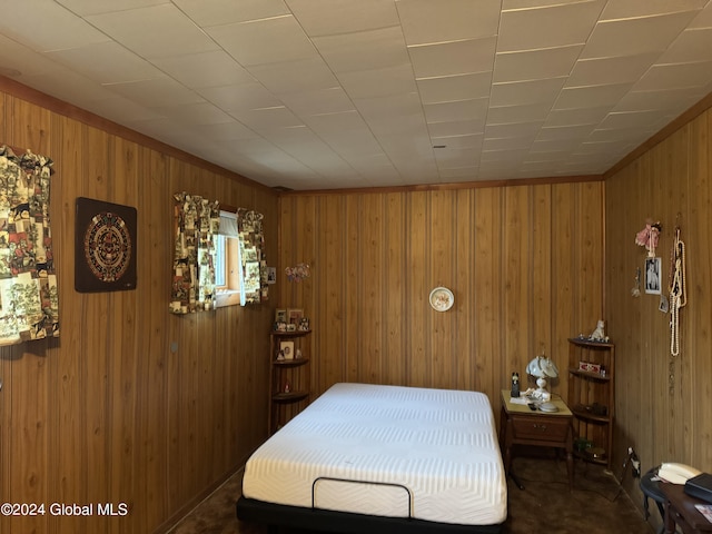 bedroom featuring wooden walls