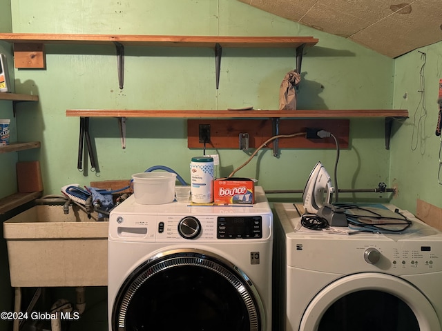 laundry area with a sink, laundry area, and washing machine and dryer