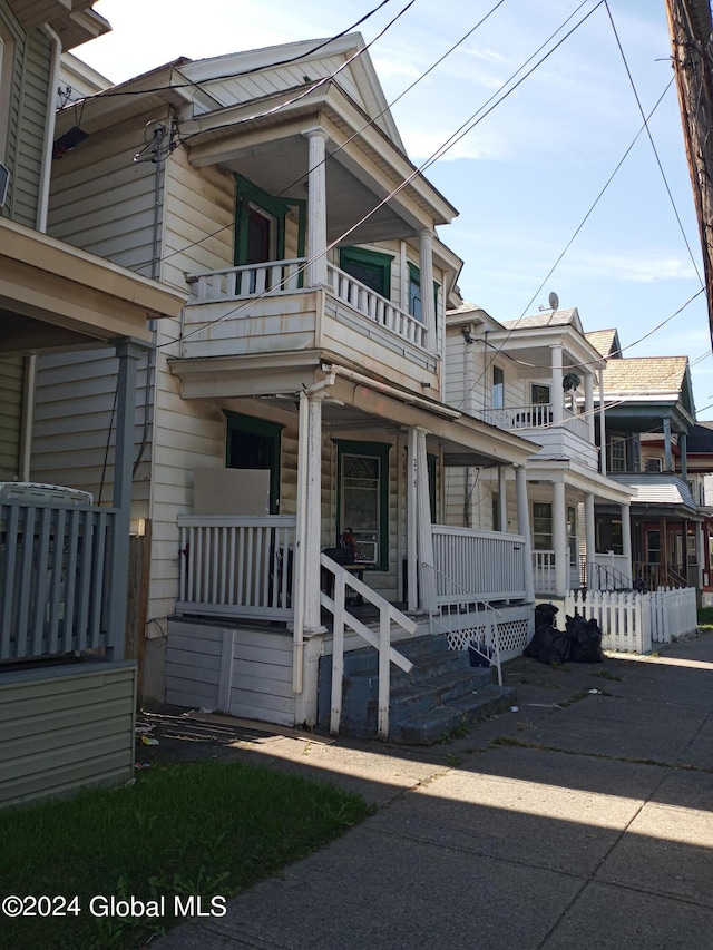 view of front of home with a balcony and covered porch