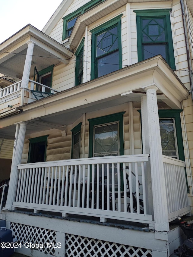 view of side of home with covered porch