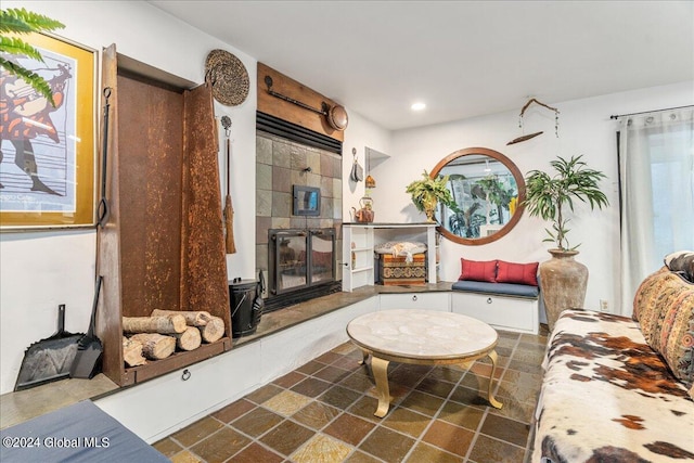 living room with plenty of natural light and a tiled fireplace