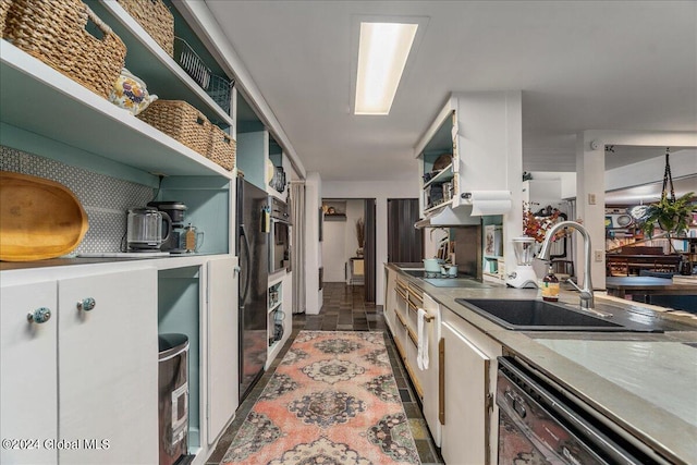 kitchen with white cabinets, dishwasher, stainless steel oven, and sink