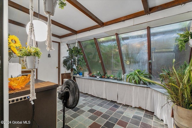 sunroom featuring beamed ceiling