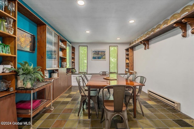 dining area with a baseboard heating unit and plenty of natural light