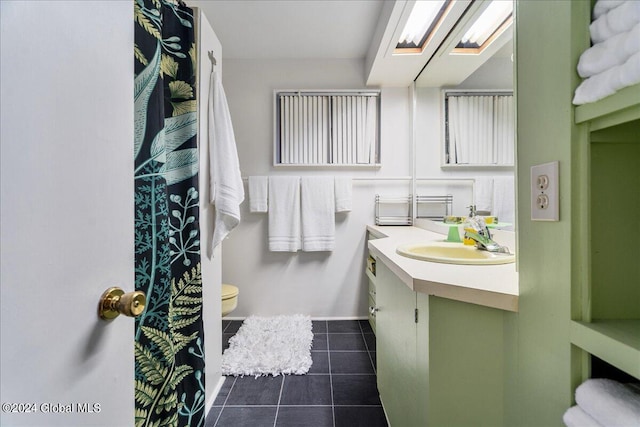 bathroom featuring vanity, toilet, and tile patterned floors