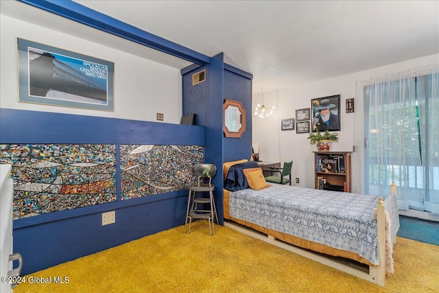 bedroom with a notable chandelier and carpet flooring