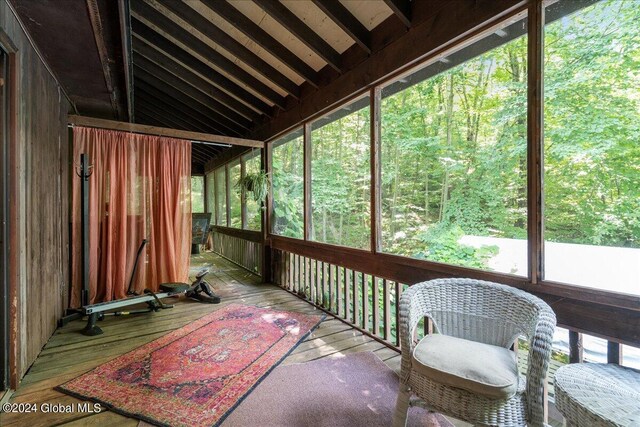 sunroom featuring vaulted ceiling