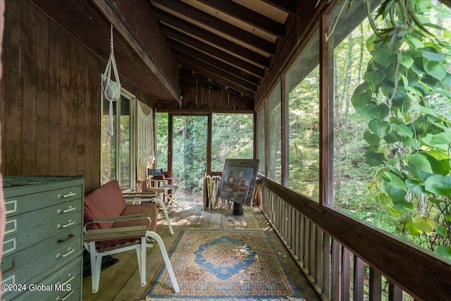 unfurnished sunroom featuring vaulted ceiling