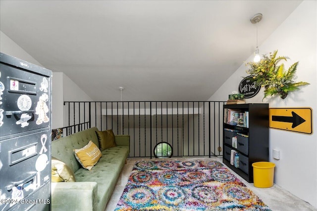 carpeted living room featuring lofted ceiling