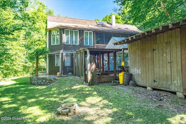 exterior space with a yard and a sunroom