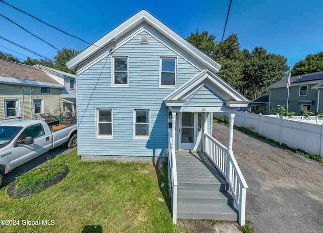 bungalow-style home with a front lawn