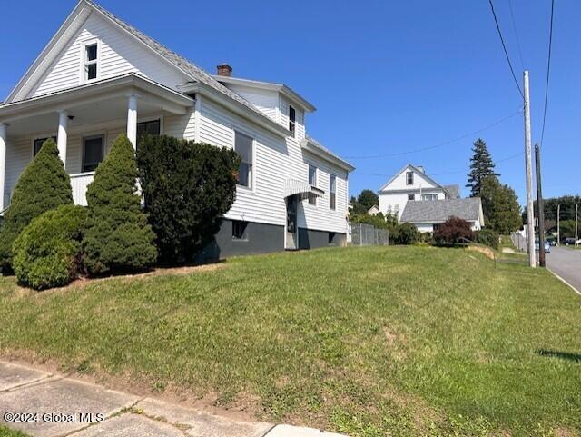 view of side of home with a lawn