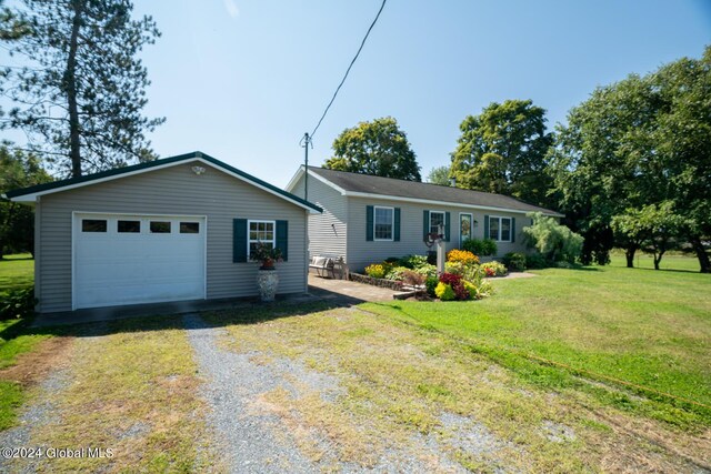 ranch-style home with a front yard and a garage