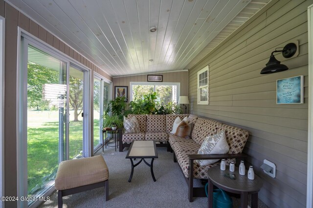 sunroom featuring wooden ceiling and lofted ceiling