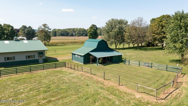 view of yard with a rural view and an outdoor structure