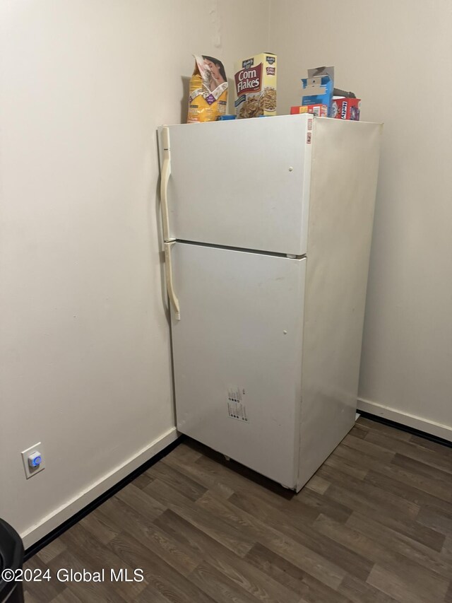 interior space featuring white fridge and dark wood-type flooring