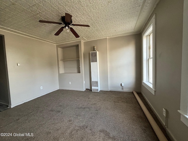 empty room with carpet, crown molding, and ceiling fan