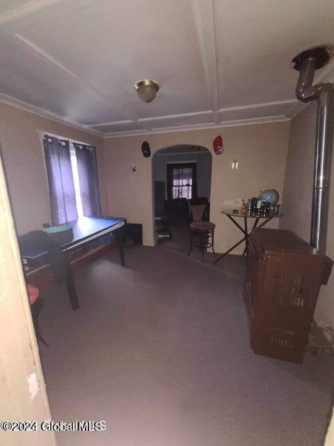 recreation room featuring carpet flooring and ornamental molding